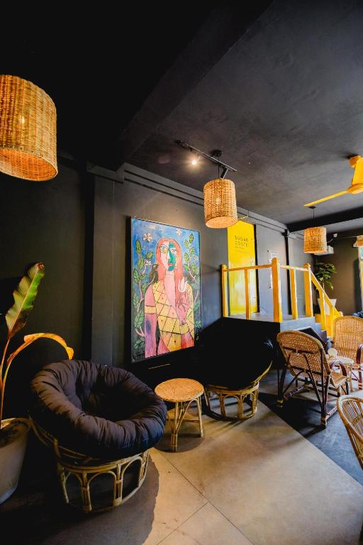 Round rattan chairs and murals in the shared lounge at Mellow Bay