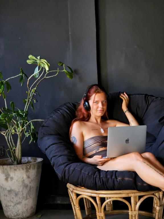 A guest working from a beanbag chair in the Mellow Bay lounge