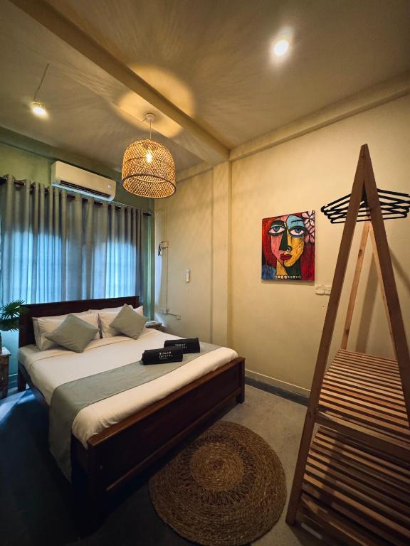 A private double room at Mellow Bay, with a mural, bedside lamp and air-conditioning