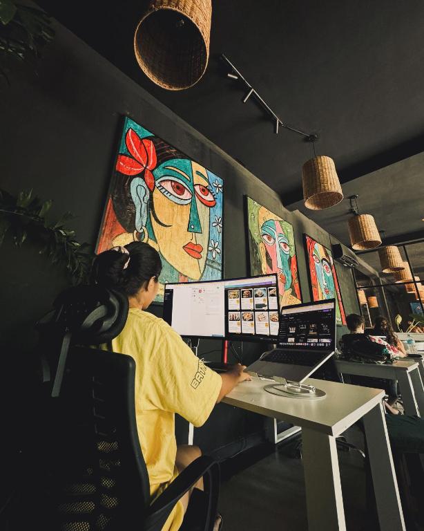 A dual-monitor workstation in the Mellow Bay coworking space in Weligama