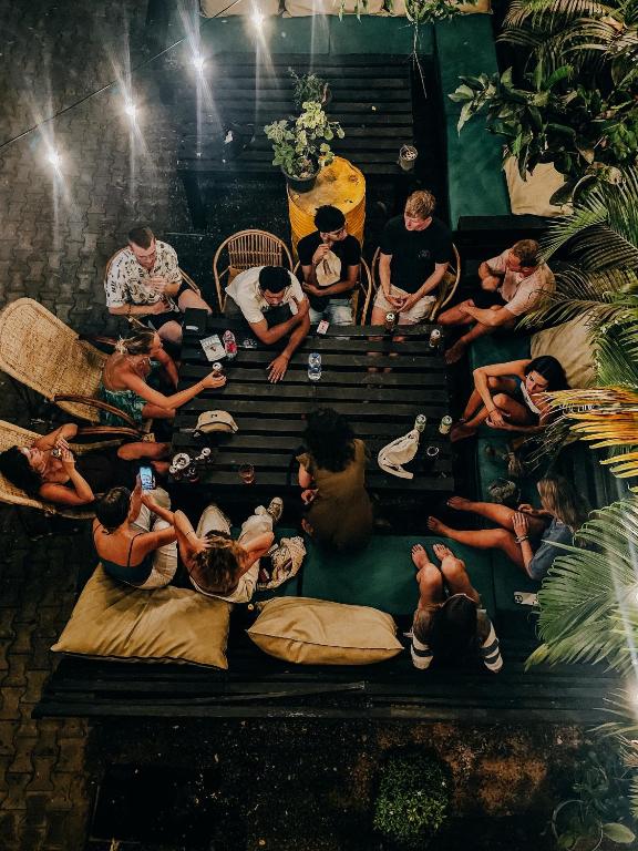 Guests spread across floor cushions on the Mellow Bay terrace in the evening